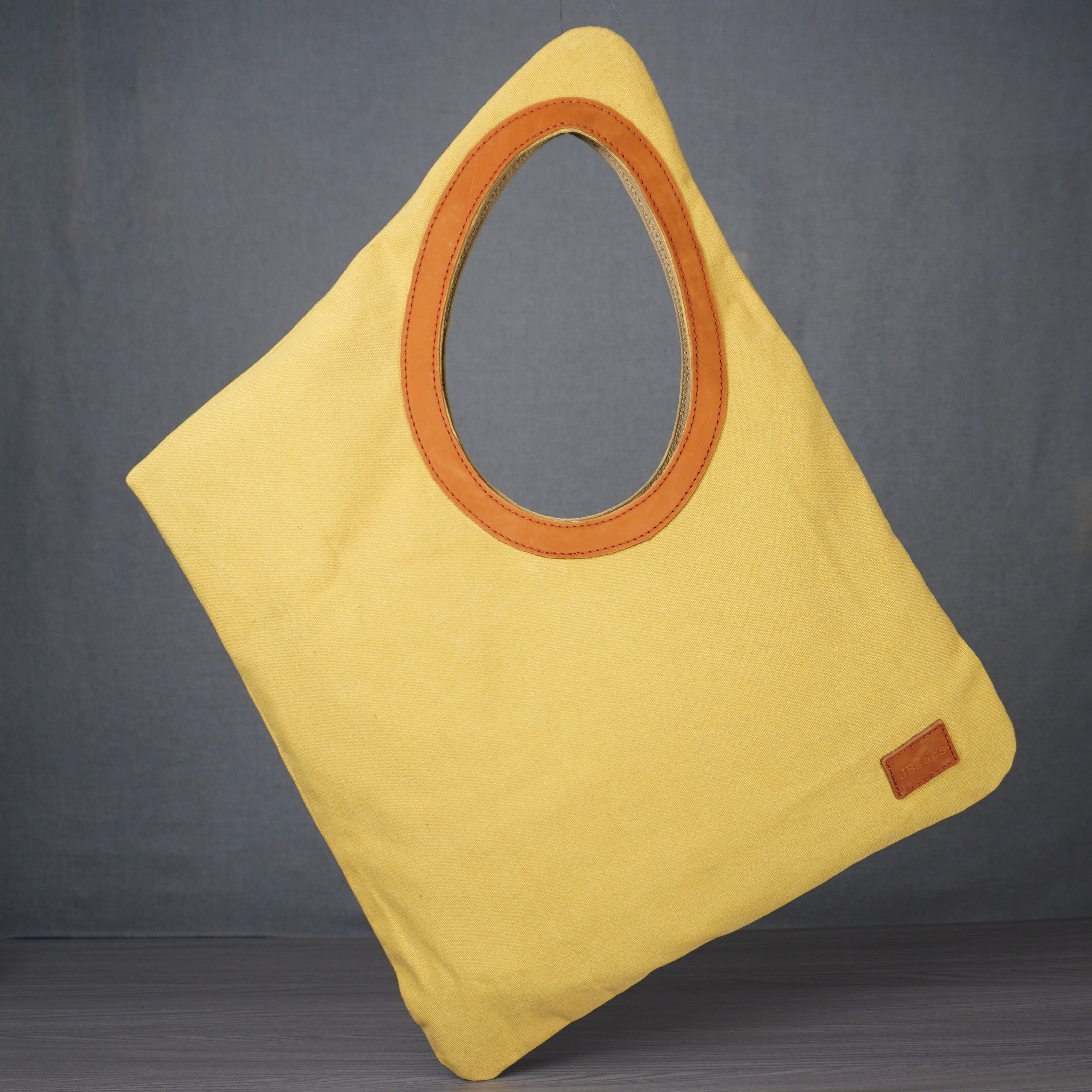 diamond shaped tote bag with leather lined hole