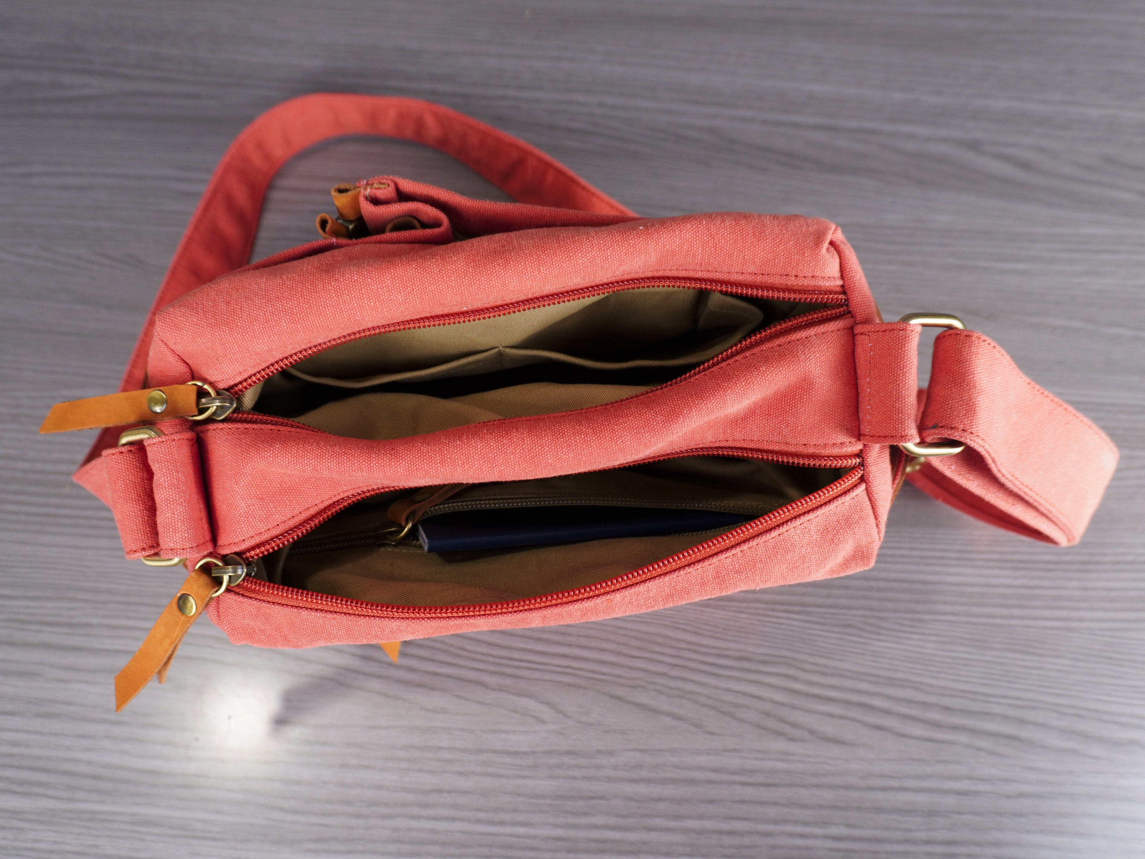 Pink handbag with gold zipper on a gray surface