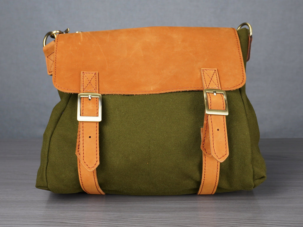 Green and orange bag on a gray surface with a plain background