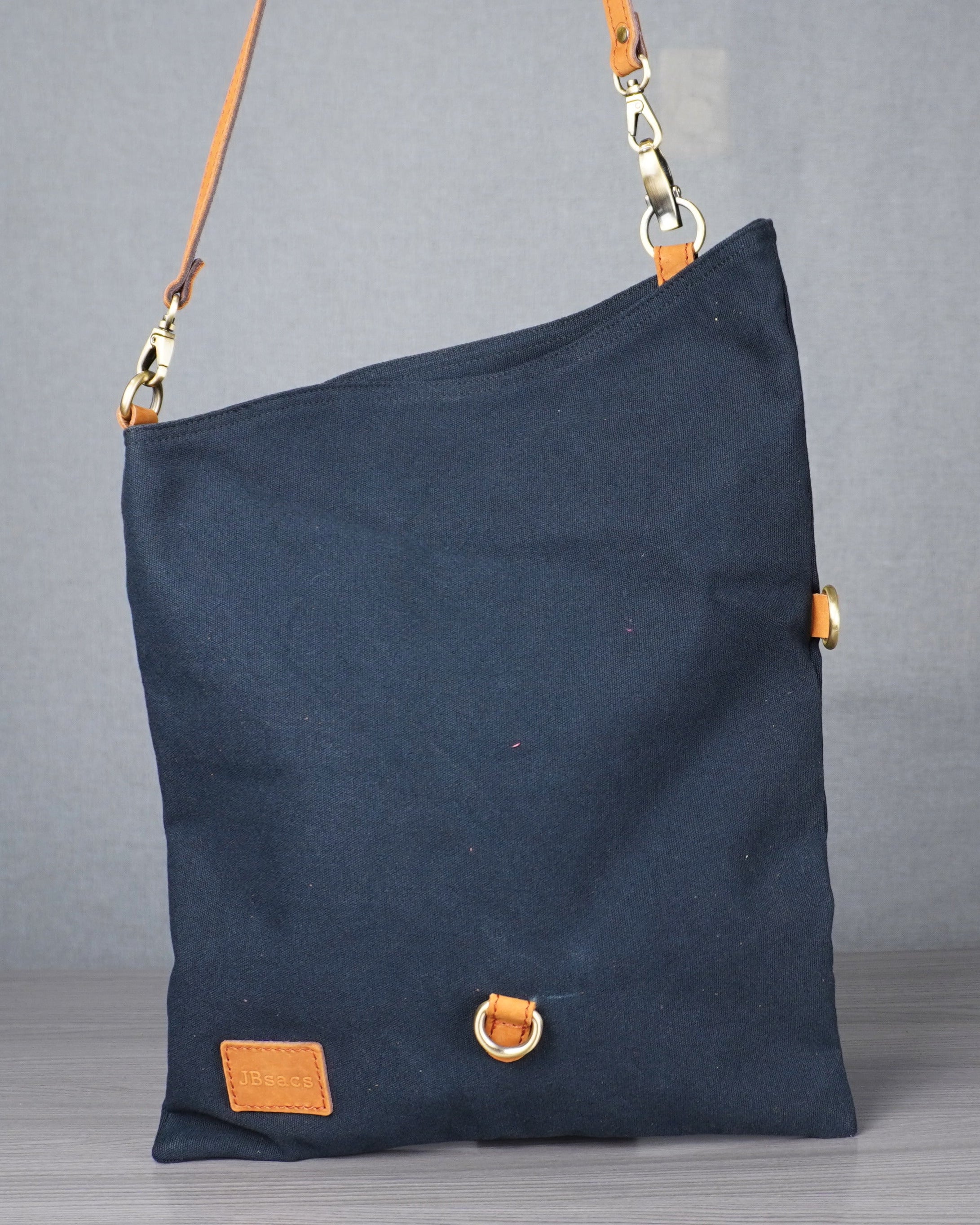 black bag with gold accents on a gray surface